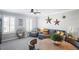 Bonus room with sectional sofa, round table, and decorative wall accents at 10507 Daybreak Gln, Parrish, FL 34219