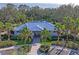 Community clubhouse with a metal roof and tropical landscaping at 10507 Daybreak Gln, Parrish, FL 34219
