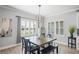 Bright dining room with wood table, black chairs, and window shutters at 10507 Daybreak Gln, Parrish, FL 34219