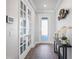 Bright entryway with hardwood floors, a console table, and access to other rooms at 10507 Daybreak Gln, Parrish, FL 34219