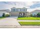 Two story home with grey siding, shutters, and a large front yard at 10507 Daybreak Gln, Parrish, FL 34219