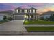 Two-story house with a large front yard, two-car garage, and neutral color scheme at 10507 Daybreak Gln, Parrish, FL 34219