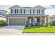 Two-story house with a two-car garage and nicely landscaped front yard at 10507 Daybreak Gln, Parrish, FL 34219