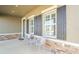 Covered front porch with seating area and stone accents at 10507 Daybreak Gln, Parrish, FL 34219
