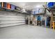 Garage with overhead storage, epoxy flooring, and wall organizers at 10507 Daybreak Gln, Parrish, FL 34219