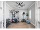 Home gym with various workout equipment and wood floors at 10507 Daybreak Gln, Parrish, FL 34219
