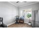 Bright home office with wood floors, large window, and printer at 10507 Daybreak Gln, Parrish, FL 34219