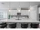 Modern kitchen island with seating and white shaker cabinets at 10507 Daybreak Gln, Parrish, FL 34219