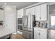 Stainless steel appliances and white cabinets in this modern kitchen at 10507 Daybreak Gln, Parrish, FL 34219