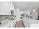 White kitchen with stainless steel appliances and light wood floors at 10507 Daybreak Gln, Parrish, FL 34219