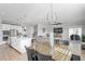 Open concept kitchen and dining area with island, stainless steel appliances, and hardwood floors at 10507 Daybreak Gln, Parrish, FL 34219