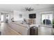 Living room with sectional sofa, large TV, and access to outdoor patio at 10507 Daybreak Gln, Parrish, FL 34219