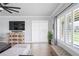 Living room with TV, sliding glass doors, and hardwood floors at 10507 Daybreak Gln, Parrish, FL 34219