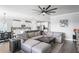 Open living space with large sectional sofa, coffee table, and access to backyard at 10507 Daybreak Gln, Parrish, FL 34219