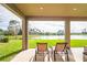 Relaxing patio overlooking a pond with lounge chairs at 10507 Daybreak Gln, Parrish, FL 34219