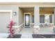 Covered porch with stone accents and two chairs, offering a relaxing outdoor space at 10507 Daybreak Gln, Parrish, FL 34219