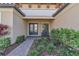 Front entryway with double doors and two chairs, manicured landscaping at 10612 Giddens Pl, Palmetto, FL 34221