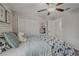 Charming bedroom with floral bedding and ceiling fan at 11628 N Castine St, New Port Richey, FL 34654