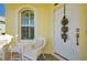 Front porch with white wicker chairs and a festive holiday decoration at 12150 Putter Green Ct, New Port Richey, FL 34654