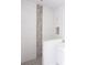 Bathroom with white tile and pebble accent wall at 142 Fairway Rd, Rotonda West, FL 33947