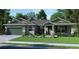 Single-story home with green garage door and stone accents at 142 Fairway Rd, Rotonda West, FL 33947