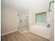 Bathroom with a large soaking tub and glass shower at 15909 Amberly Dr, Tampa, FL 33647