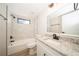 Updated bathroom with marble tile, granite countertop, and bathtub at 15909 Amberly Dr, Tampa, FL 33647