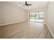 Spacious bedroom with wood-look floors and sliding doors to pool area at 15909 Amberly Dr, Tampa, FL 33647