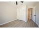 Bedroom with wood-look floors, a closet, and access to hallway at 15909 Amberly Dr, Tampa, FL 33647