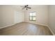 Spacious bedroom with laminate floors, a ceiling fan, and a large closet at 15909 Amberly Dr, Tampa, FL 33647