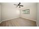Bright bedroom with laminate wood flooring and a ceiling fan at 15909 Amberly Dr, Tampa, FL 33647