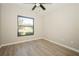 Bright bedroom with wood-look floors and a large window at 15909 Amberly Dr, Tampa, FL 33647