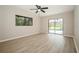 Spacious bedroom with wood-look floors and sliding doors to pool at 15909 Amberly Dr, Tampa, FL 33647