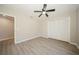 Well-lit bedroom with laminate floors, ceiling fan and access to a bathroom at 15909 Amberly Dr, Tampa, FL 33647
