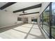 Sunlit living room with exposed beams, pool view, and hardwood floors at 15909 Amberly Dr, Tampa, FL 33647