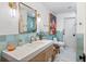 Spa-like bathroom with light blue tile, quartz countertop, and modern fixtures at 1690 Fox Rd, Clearwater, FL 33764