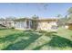 House backyard with Florida room and green lawn at 1736 Colorado Ne Ave, St Petersburg, FL 33703