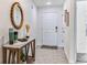 Bright entryway with wood console table, mirror, and tile flooring at 1804 Tahitian Sunrise Dr, Plant City, FL 33565