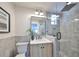 Light wood vanity, frameless shower, and gray tile at 1846 3Rd S St, St Petersburg, FL 33705