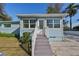 Front view of charming house with white steps and railing at 1846 3Rd S St, St Petersburg, FL 33705