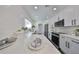 White kitchen with stainless steel appliances and quartz countertops at 1846 3Rd S St, St Petersburg, FL 33705
