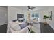 Bright living room with comfy sofas, dark hardwood floors, and large sliding glass doors at 1846 3Rd S St, St Petersburg, FL 33705