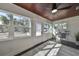 Sunroom with wood ceiling, hardwood floors and view of street at 1846 3Rd S St, St Petersburg, FL 33705