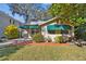 Brick home with green awnings, a brick walkway, and a well-manicured lawn at 2925 W Tambay Ave, Tampa, FL 33611