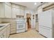 Galley kitchen with white appliances and ample cabinet space at 2925 W Tambay Ave, Tampa, FL 33611