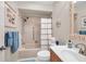 Clean bathroom with a shower/tub combo, vanity, and decorative mirror at 460 Paula S Dr # 101, Dunedin, FL 34698