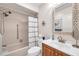 Updated bathroom with tub/shower, vanity, and decorative mirror at 460 Paula S Dr # 101, Dunedin, FL 34698