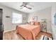 Bright bedroom with a comfortable bed, ceiling fan, and plenty of closet space at 460 Paula S Dr # 101, Dunedin, FL 34698