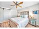 Serene bedroom with a rustic wooden bed frame and ceiling fan at 460 Paula S Dr # 101, Dunedin, FL 34698