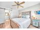 Charming bedroom with rustic bed frame and ceiling fan at 460 Paula S Dr # 101, Dunedin, FL 34698